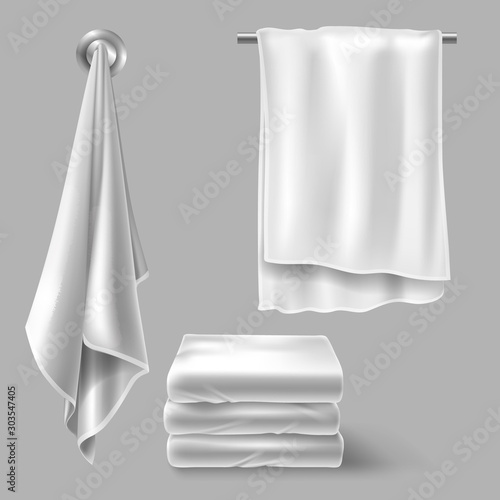White cloth towels on hangers and folded in stack. Vector realistic mockup of fabric towels for bathroom, spa hotel, beach or kitchen isolated on gray background