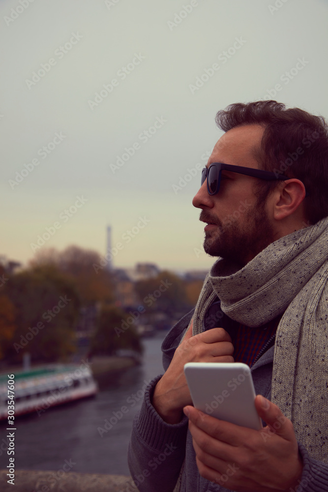 Handsome man using cellphone while enjoying in Paris. Handsome man using cellphone while enjoying in Paris.