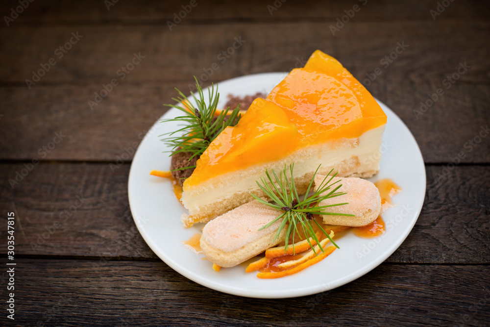Peach creramy cake topped with jelly, peace of peach cake closeup Peach creramy cake topped with jelly, peace of peach cake closeup