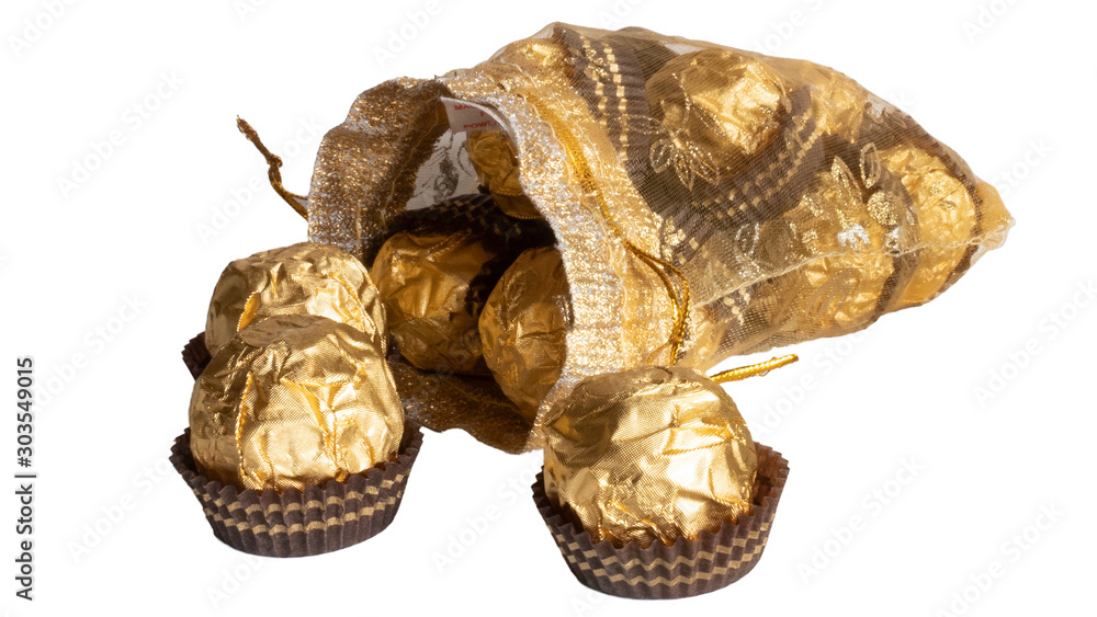 Candy in gold wrappers, isolated on white background Candy in gold wrappers, isolated on white background