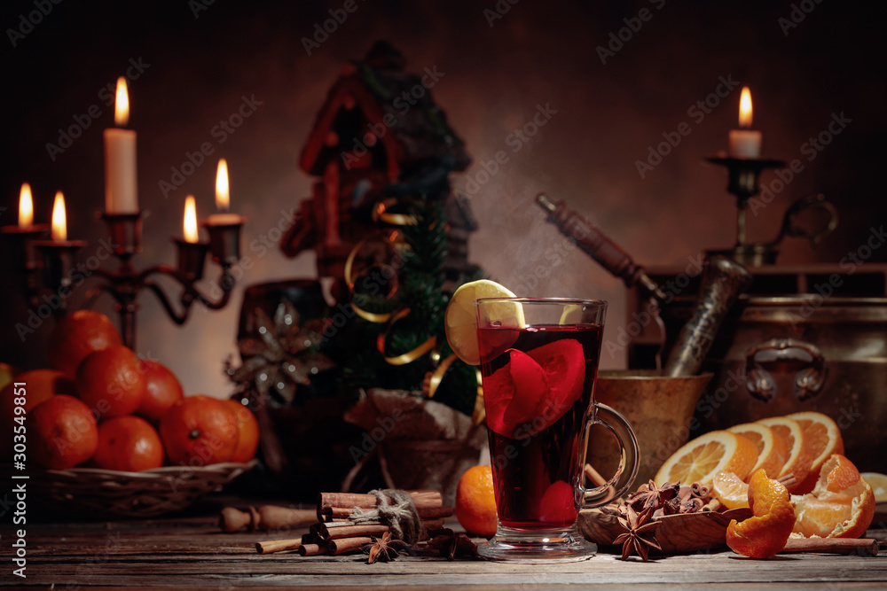 Mulled wine and Christmas decorations with candlesticks.