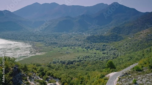 Mountains and a road near Lake Skadar, Montenegro. Aerial, drone flyover footage. photo