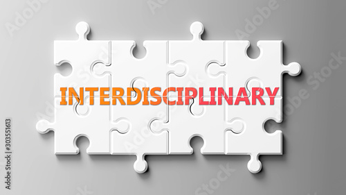 Interdisciplinary complex like a puzzle - pictured as word Interdisciplinary on a puzzle to show that it can be difficult and needs cooperating pieces that fit together, 3d illustration photo