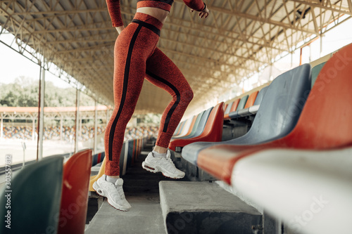 Portrait of One Sports Fitness Girl Dressed Fashion Sportswear Outfit Doing Jogging and Run at the City Stadium, Healthy Lifestyle Concept