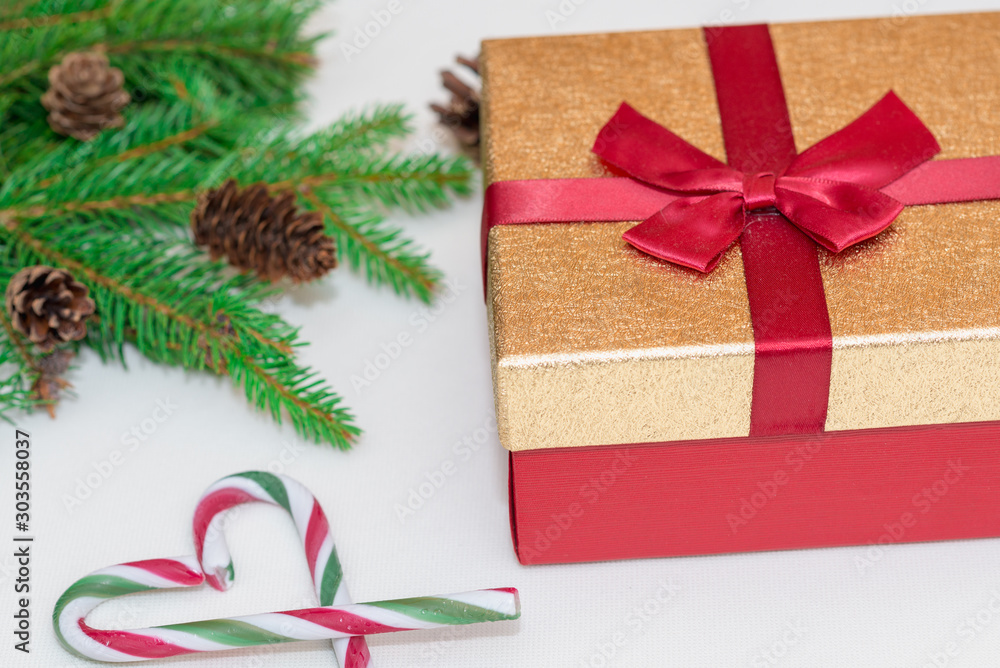 Christmas concept, new year concept. Gift Box, candy staff,candy canes as heart Christmas tree branches, Fir tree branches,close up. Christmas concept, new year concept. Gift Box, candy staff,candy canes as heart Christmas tree branches, Fir tree branches,close up.