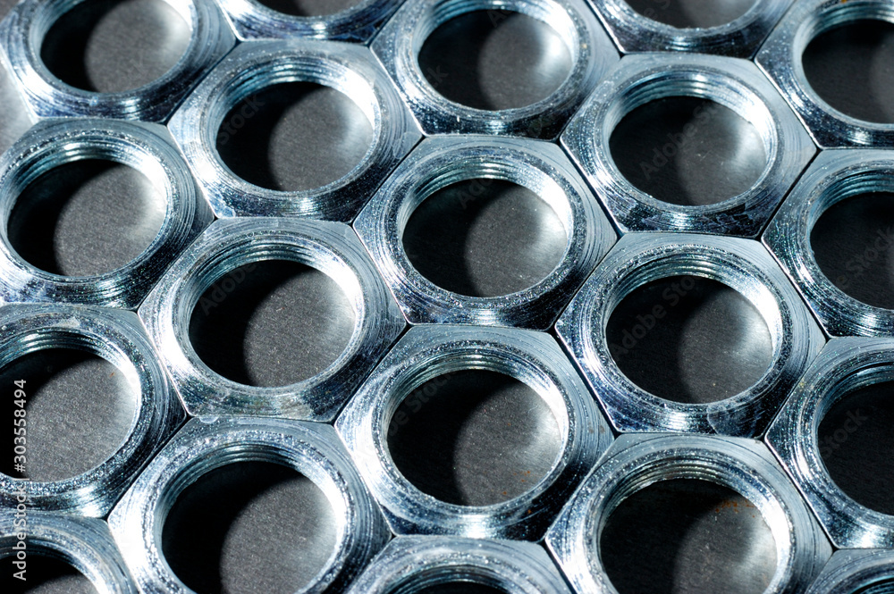 Close-up chrome metal nuts. Metal lines Close-up chrome metal nuts. Metal lines
