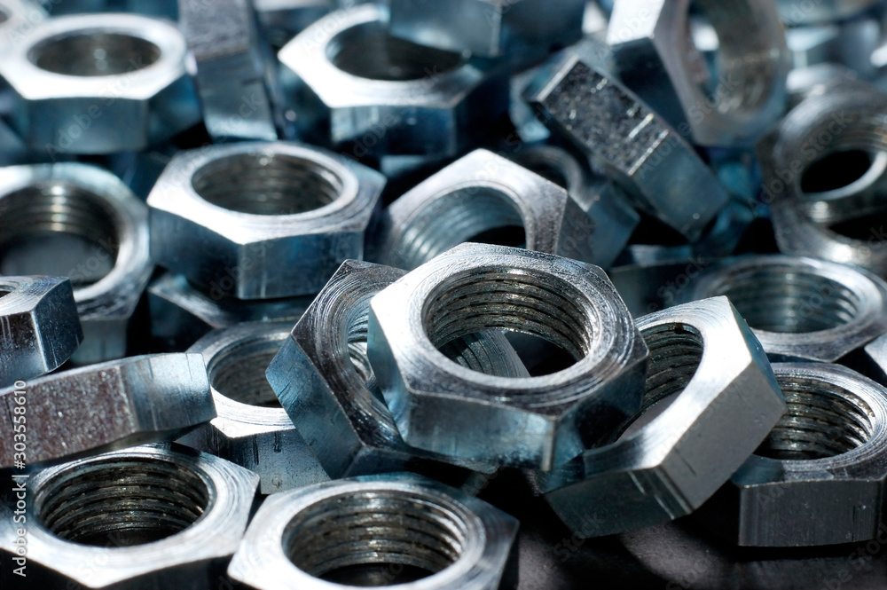 Side view close-up chrome metal nuts Side view close-up chrome metal nuts