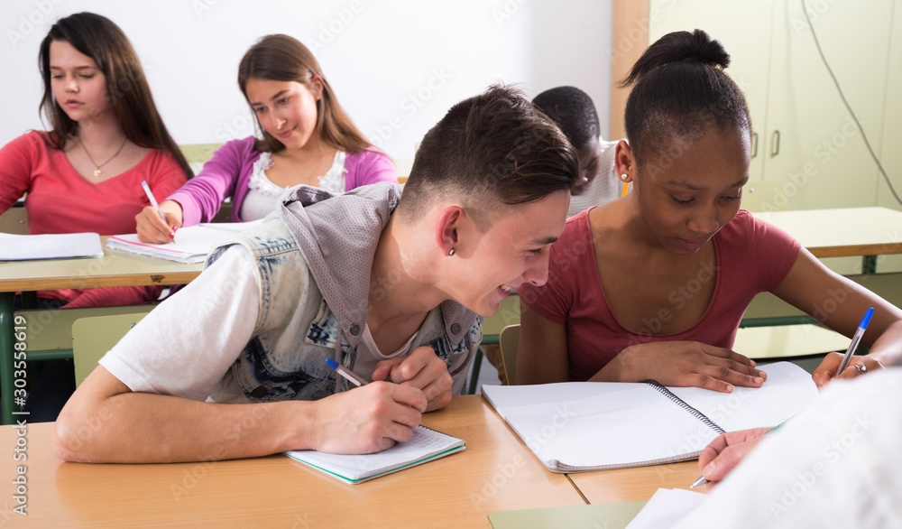student write off from notebook African-American students in classroom student write off from notebook African-American students in classroom