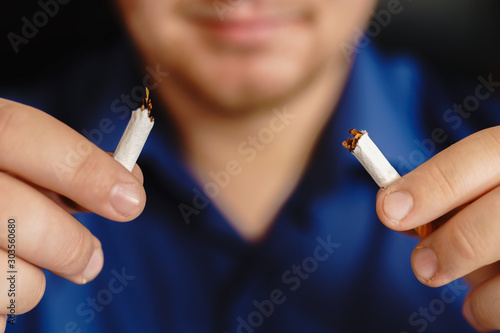 Man hands breaking the cigarette. Stop smoking in car concept. destroy cigarette by hand.