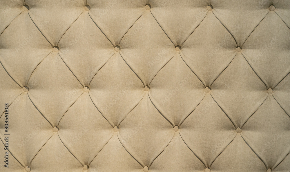 Fototapeta premium Chesterfield style quilted upholstery backdrop close up. Capitone pattern texture background