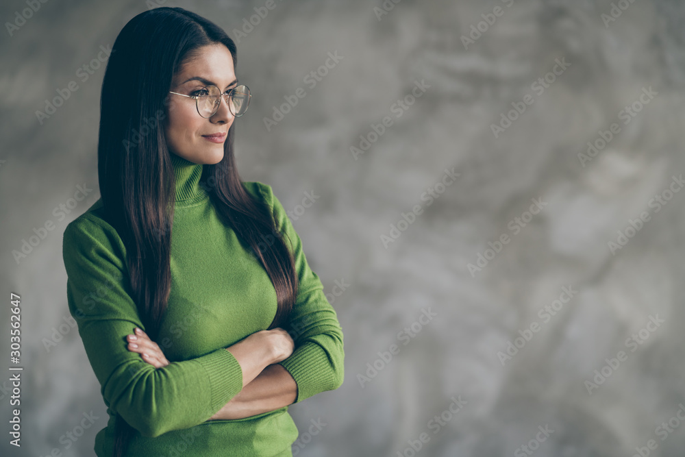 Photo of serious confident woman looking into empty space with arms crossed dreaming about successful future isolated grey wall concrete color background Photo of serious confident woman looking into empty space with arms crossed dreaming about successful future isolated grey wall concrete color background