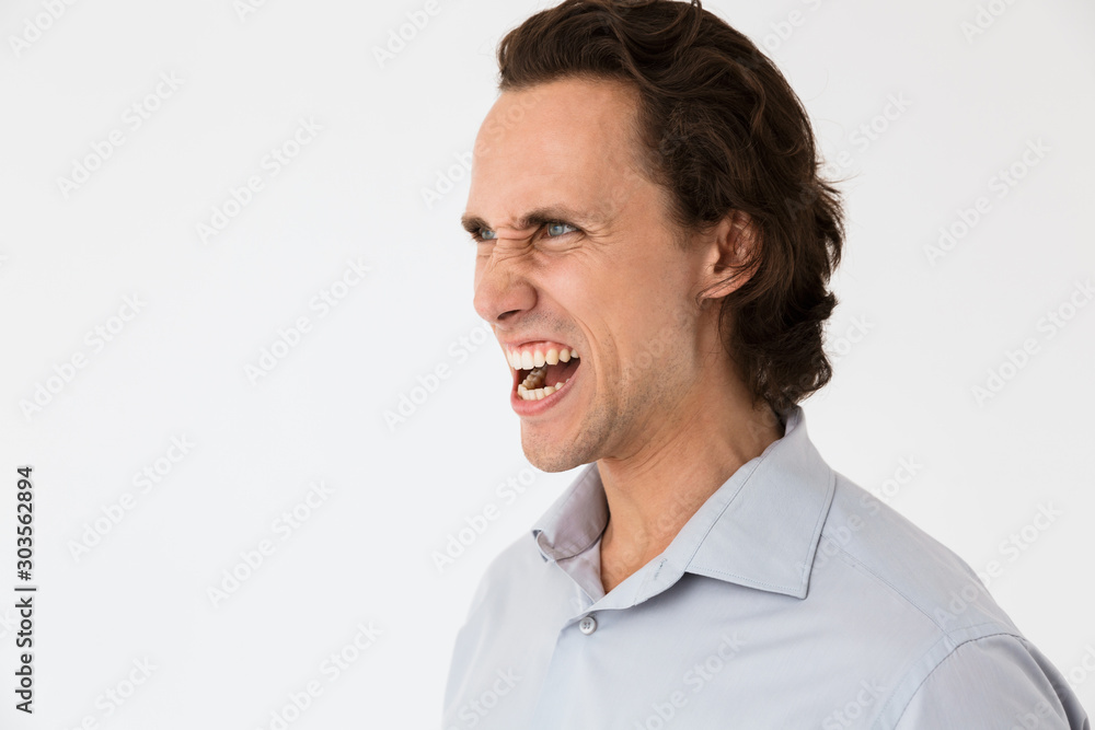 Image of annoyed businessman in office shirt screaming in anger Image of annoyed businessman in office shirt screaming in anger