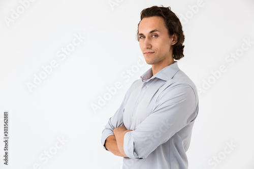 Image of attractive businessman in office shirt looking at camera