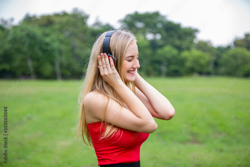 Headshot Portrait of happy girl with smiling looking at camera against plant background. Student and teenage lifestyle concept Headshot Portrait of happy girl with smiling looking at camera against plant background. Student and teenage lifestyle concept