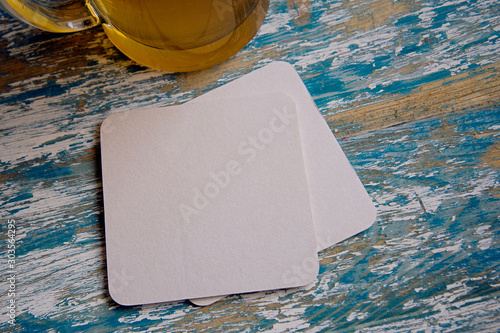 empty blank cardboard beermat on wood mockup