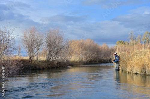 Fly fisherman in a river in Montana in autumn