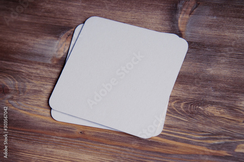 empty blank cardboard beermat on wood mockup