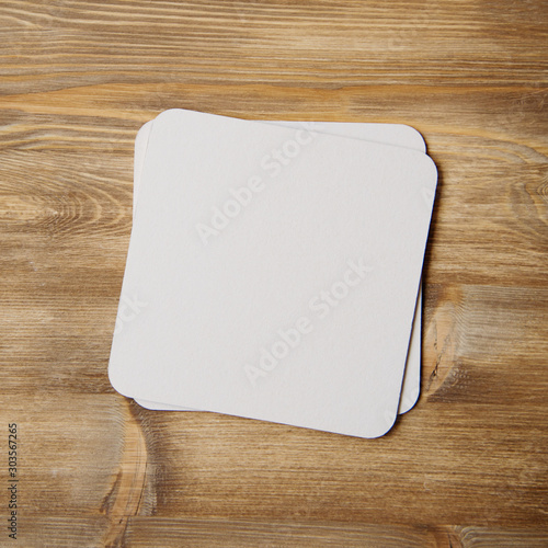 empty blank cardboard beermat on wood mockup