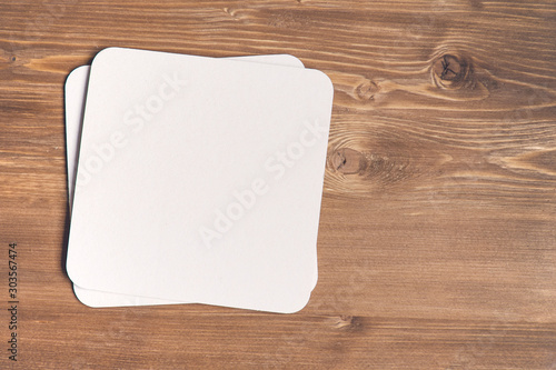 empty blank cardboard beermat on wood mockup