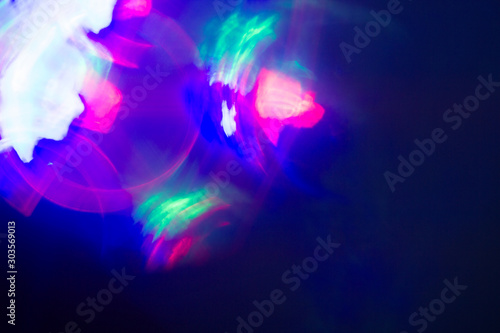 Blurred lens flare. Defocused colorful lights. Shiny glowing spots, abstract background and texture