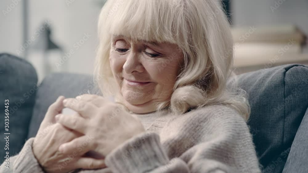 Senior woman with dementia looking at photos Senior woman with dementia looking at photos
