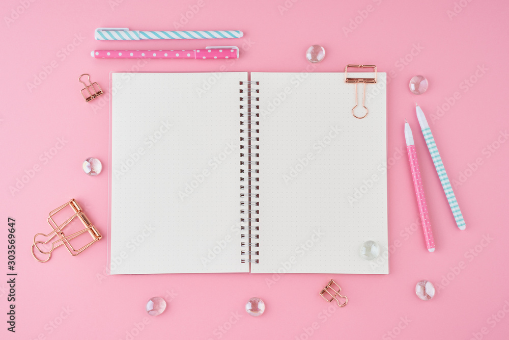 Blank notepad page in bullet journal on bright pink office desktop. Top view of modern bright table with notebook, stationery. Mock up, copy space, concept for diary Blank notepad page in bullet journal on bright pink office desktop. Top view of modern bright table with notebook, stationery. Mock up, copy space, concept for diary