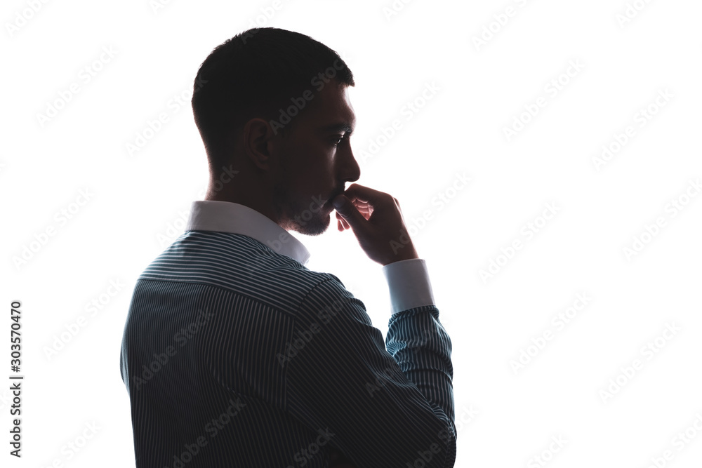 Φωτογραφία silhouette of a Caucasian man on the side in a business shirt hand at the mouth,