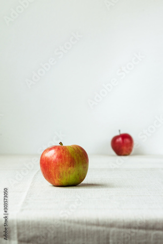 Red-green apple on a table on a white background  close up
