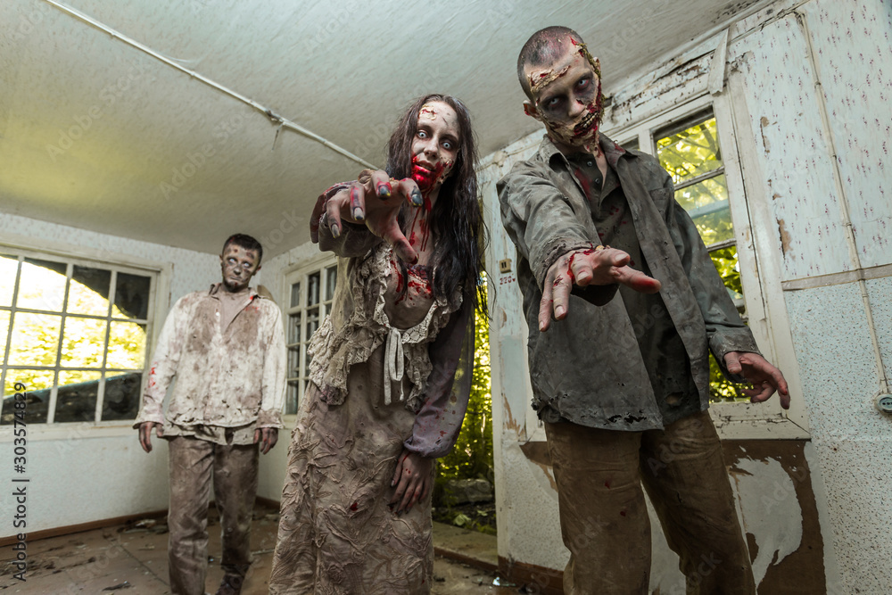 Fotografie Zombies come into an abandoned house