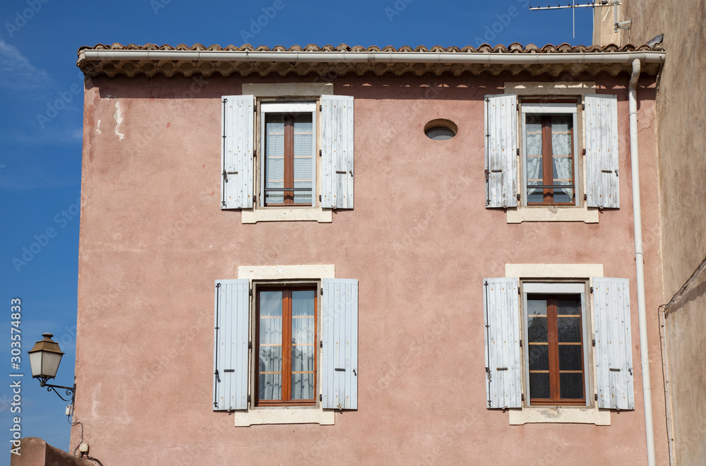 Pink house facade in the old town area of Beziers, France.