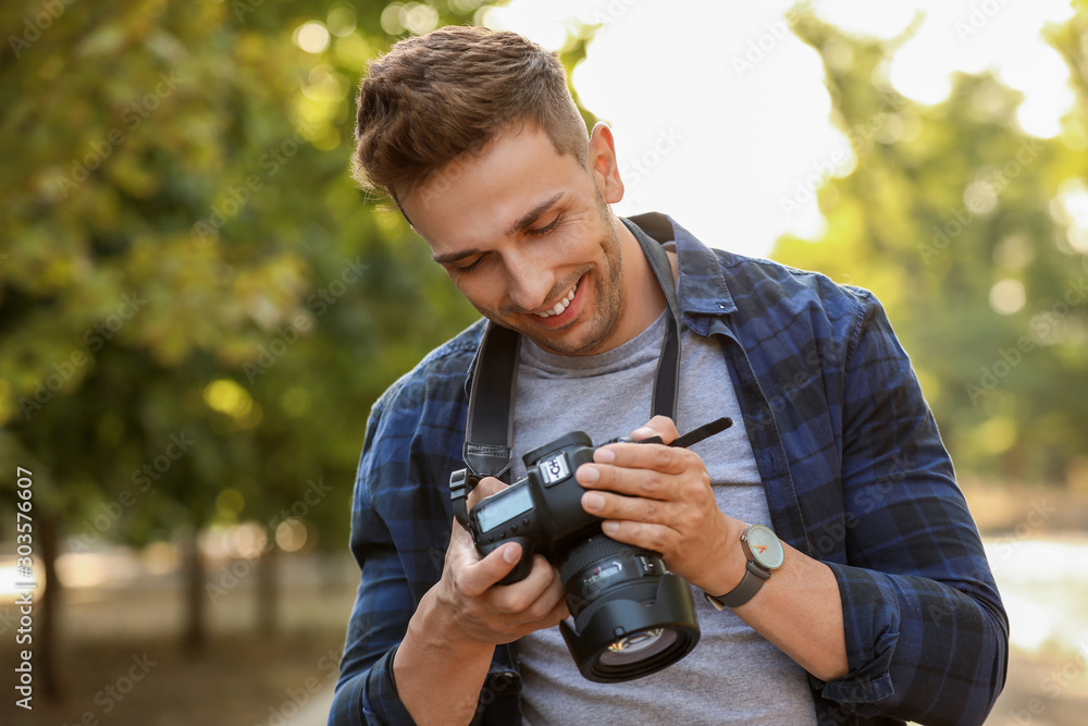 Handsome male photographer with camera outdoors Handsome male photographer with camera outdoors