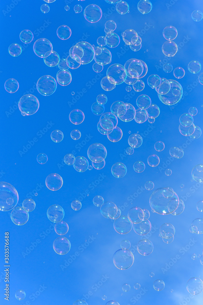 Soap bubbles against blurred blue sky background Soap bubbles against blurred blue sky background