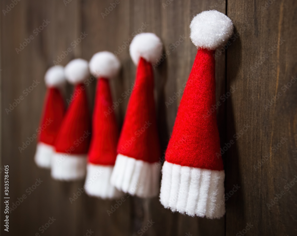 Little Santa Claus hats. Christmas tree toys handmade. Christmas Wooden background. Christmas ornaments. Little Santa Claus hats. Christmas tree toys handmade. Christmas Wooden background. Christmas ornaments.