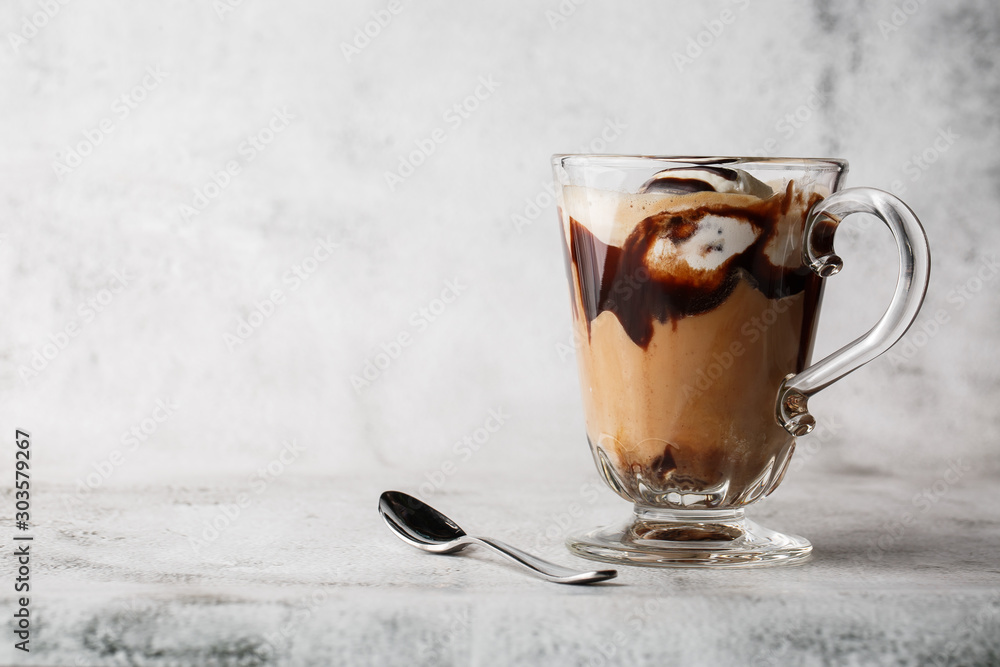 Chocolate frappe with whipped cream, chocolate syrup and ice cream on bright marble background. Overhead view, copy space. Advertising for cafe menu. Coffee shop menu. Horizontal photo.