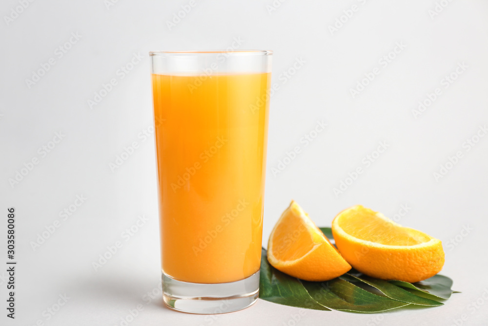 Glass of fresh orange juice on light background Glass of fresh orange juice on light background