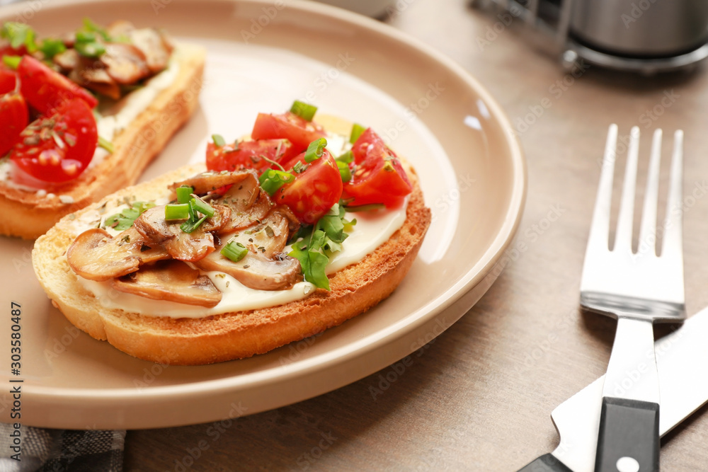 Plate with tasty sandwiches on table, closeup