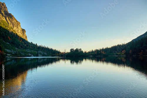 Fototapeta Naklejka Na Ścianę i Meble -  Poprad lake after sunset with refletion on silhouettes on water in High Tatras mountain National Park, Slovakia