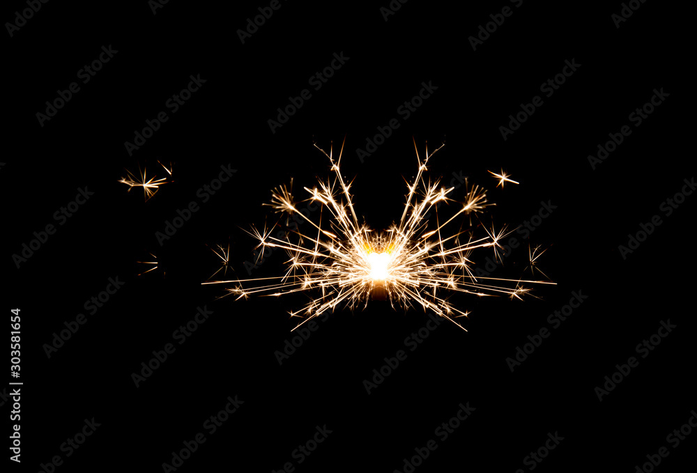 One small new year sparkler on black background