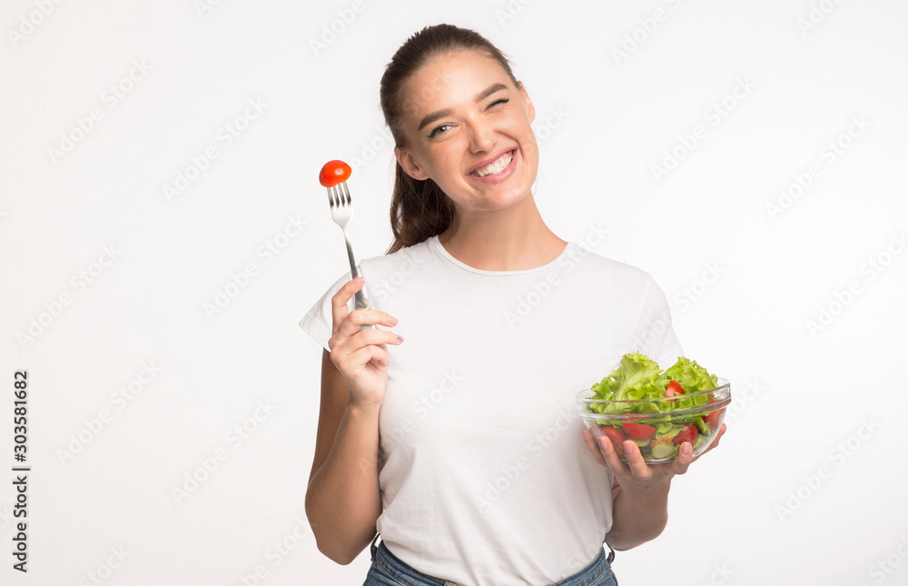Lady Eating Vegetable Salad Winking Standing On White Background Lady Eating Vegetable Salad Winking Standing On White Background