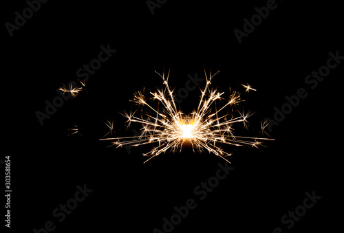 One small new year sparkler on black background