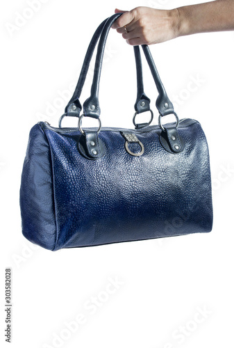 Beautiful leather travel bag in hands isolated on a white background.
