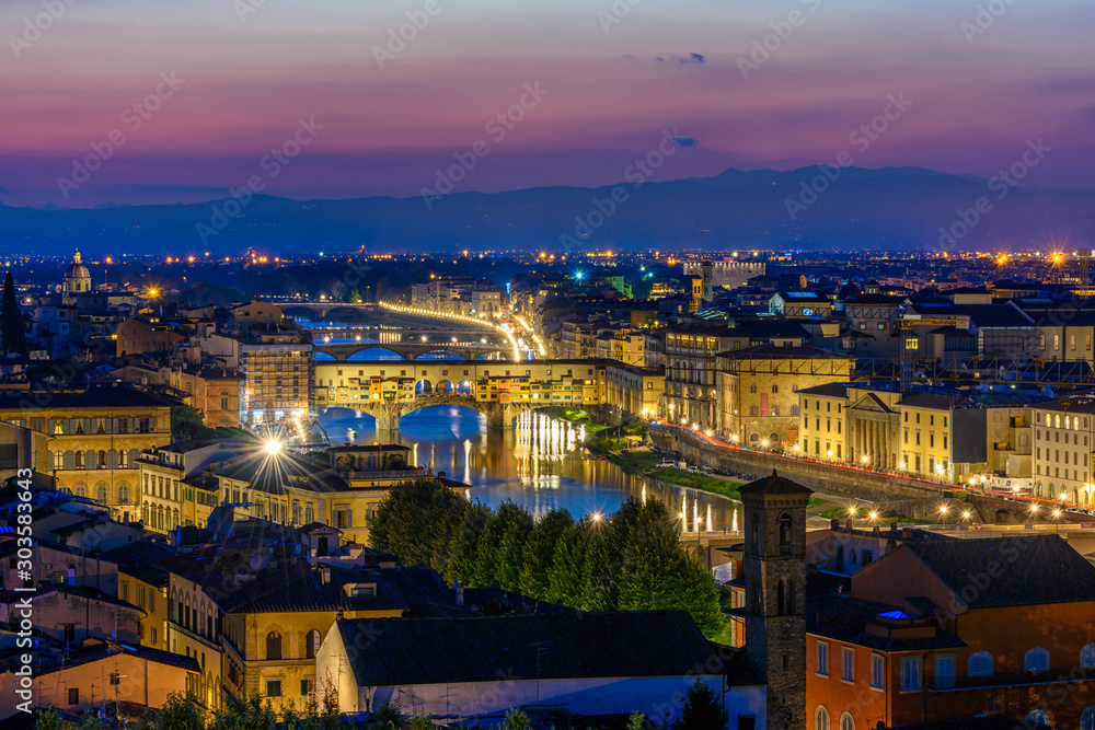 Night view of Ponte Vecchio over Arno River in Florence, Italy. Architecture and landmark of Florence. Skyline of Florence