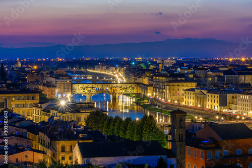 Night view of Ponte Vecchio over Arno River in Florence, Italy. Architecture and landmark of Florence. Skyline of Florence