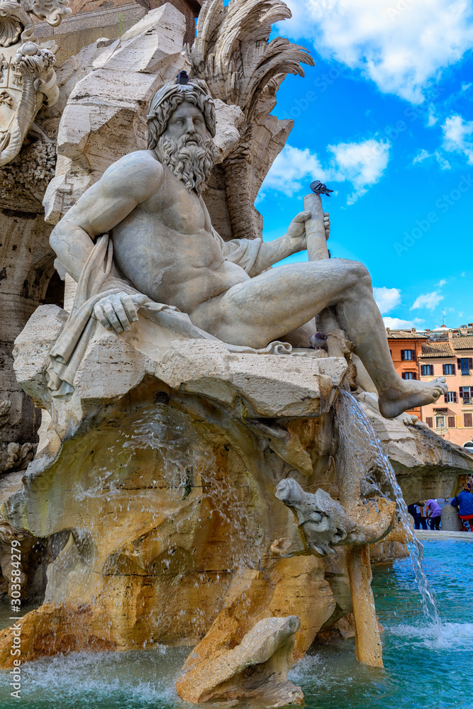 Fountain of the Four Rivers (Fontana dei Quattro Fiumi) with an Egyptian obelisk on Piazza Navona, Rome, Italy. Architecture and landmark of Rome. Postcard of Rome.