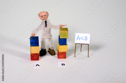 Fotografie Mathematics setup with inequality:  A is less than B, with the corresponding denotion on the blackboard