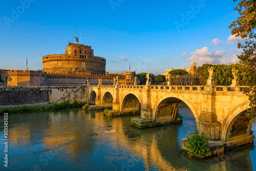 Castle Sant Angelo (Mausoleum of Hadrian), bridge Sant Angelo and river Tiber in the rays of sunset in Roma. Italy. Architecture and landmark of Rome. Cityscape of Rome.