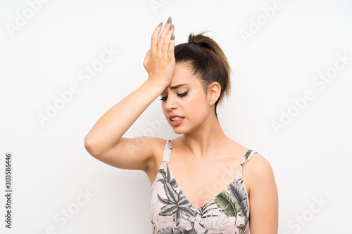 Young woman over isolated white background having doubts with confuse face expression