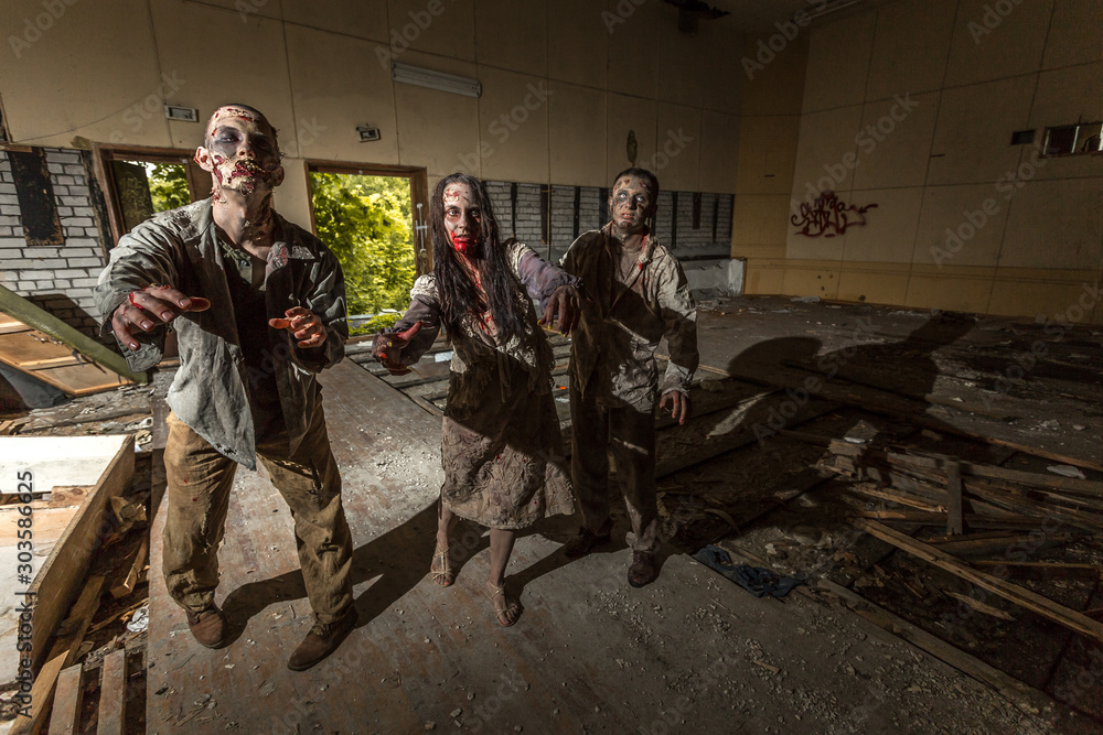 Fototapeta premium Zombies attack in an abandoned dark building