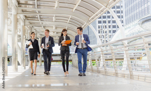 Group of businessman and businesswoman walking and meeting together outdoor