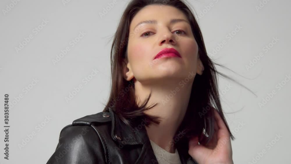 Beauty 30s woman with hair blowing in studio shoot Beauty 30s woman with hair blowing in studio shoot